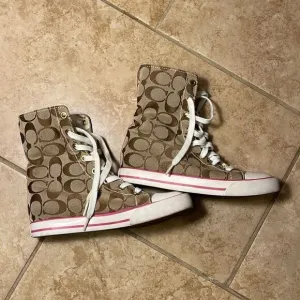 Coach pink high top reversible sneakers.
