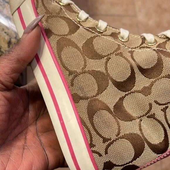 Coach pink high top reversible sneakers.
