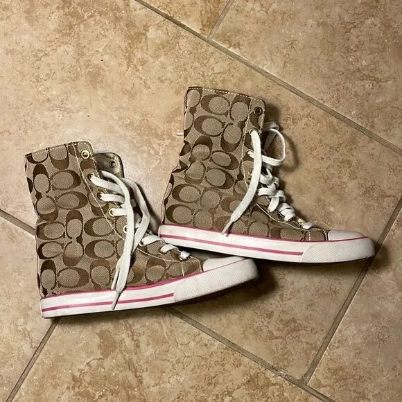 Coach pink high top reversible sneakers.