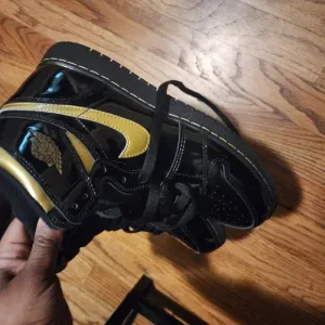 Jordan Black and Gold High-Top Sneakers