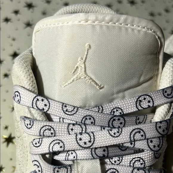 Nike Jordan 1 Low craft series (white) with smiley face shoelaces.