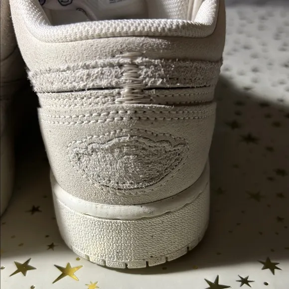 Nike Jordan 1 Low craft series (white) with smiley face shoelaces.