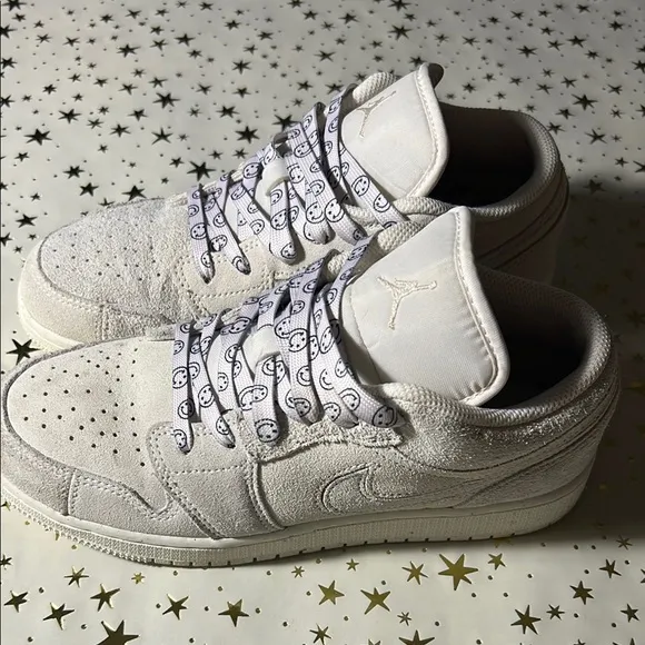 Nike Jordan 1 Low craft series (white) with smiley face shoelaces.