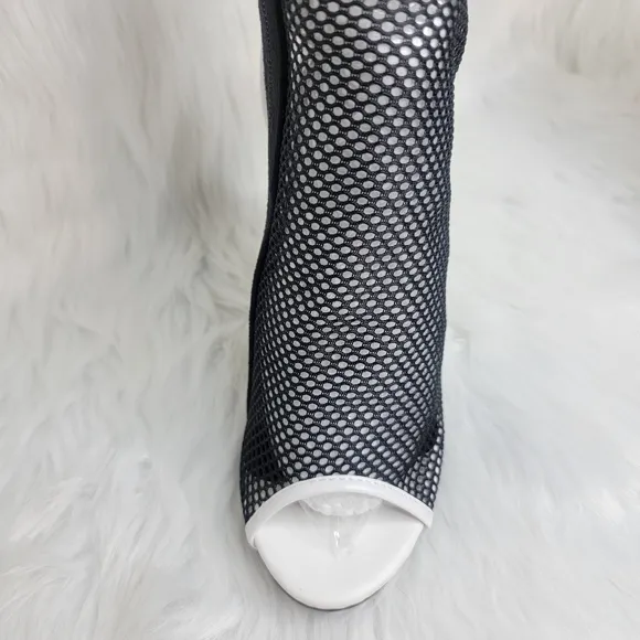 Open toe black mesh stiletto heeled ankle boots.