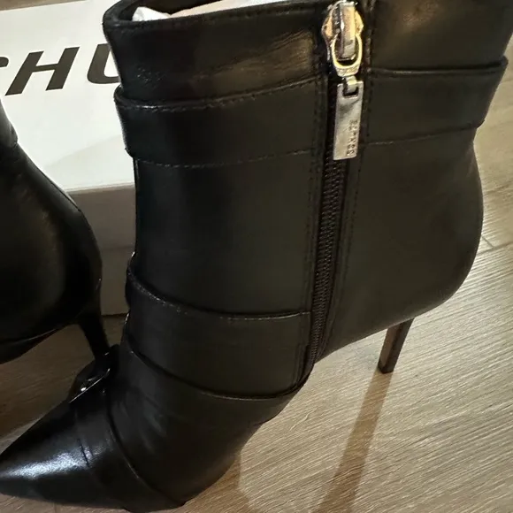 These boots are sleek black leather ankle boots by Schutz.