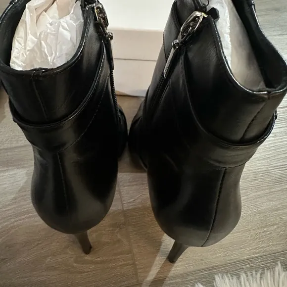 These boots are sleek black leather ankle boots by Schutz.