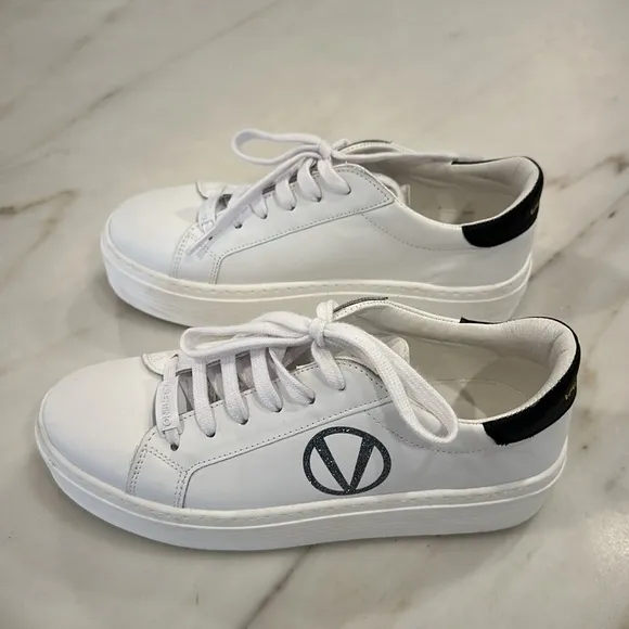 Valentino White platform sneakers with black glittery V in women’s size 8.